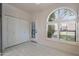 Bright room with arched window with shutter blinds, door, and closet at 4116 E Sunnyside Dr, Phoenix, AZ 85028