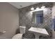 Bathroom featuring a pedestal sink, tiled wall, and fixtures at 4248 N Parkway Ave, Scottsdale, AZ 85251