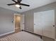 Neutral bedroom showcasing a bed with striped bedding, a ceiling fan, and a spacious closet at 4248 N Parkway Ave, Scottsdale, AZ 85251