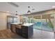 Modern kitchen with a large island, stainless steel appliances, and a view of the outdoor patio at 4248 N Parkway Ave, Scottsdale, AZ 85251