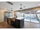 Modern kitchen with a large island, stainless steel appliances, and a view of the outdoor patio at 4248 N Parkway Ave, Scottsdale, AZ 85251