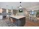 Open-concept kitchen featuring an island with bar seating and wood floors throughout the home at 4248 N Parkway Ave, Scottsdale, AZ 85251