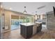 Spacious kitchen with an island, access to outdoor patio, and a view into the living area at 4248 N Parkway Ave, Scottsdale, AZ 85251
