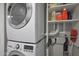 Laundry room featuring stacked washer and dryer, with storage shelves at 4248 N Parkway Ave, Scottsdale, AZ 85251