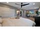 Spacious main bedroom with sliding barn doors to bathroom, a ceiling fan, and a mounted television at 4248 N Parkway Ave, Scottsdale, AZ 85251