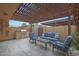 Inviting outdoor patio area with comfortable seating and a built-in grill at 4248 N Parkway Ave, Scottsdale, AZ 85251
