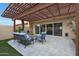 Charming outdoor patio with pergola features comfortable seating, ideal for relaxing and entertaining at 4248 N Parkway Ave, Scottsdale, AZ 85251