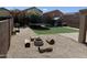 Spacious backyard with artificial turf, a trampoline, a fire pit, landscaping and an outdoor shed at 42775 W Jeremy St, Maricopa, AZ 85138