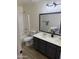 Bathroom featuring double sinks, a large mirror, and a shower-tub combo with white tile surround at 42775 W Jeremy St, Maricopa, AZ 85138