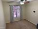 Neutral bedroom with carpet, a ceiling fan, and large windows that allow in ample natural light at 42775 W Jeremy St, Maricopa, AZ 85138