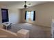 Bonus room featuring carpet floors, lots of natural light, and a play area with table and chairs at 42775 W Jeremy St, Maricopa, AZ 85138