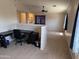 Open bonus room area with carpet flooring, a ceiling fan, and a functional desk space at 42775 W Jeremy St, Maricopa, AZ 85138