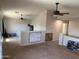 Spacious upstairs bonus room featuring vaulted ceilings, carpet flooring, and multiple ceiling fans at 42775 W Jeremy St, Maricopa, AZ 85138