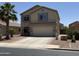 Charming two-story home with a two car garage, desert landscaping, and a beautiful palm tree at 42775 W Jeremy St, Maricopa, AZ 85138