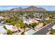 Picturesque aerial view of a neighborhood featuring lush landscaping, swimming pool, and mountain backdrop at 4317 E Glenrosa Ave, Phoenix, AZ 85018