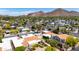 Scenic aerial view showcasing residential properties with mature trees, well-maintained streets, and stunning mountain views at 4317 E Glenrosa Ave, Phoenix, AZ 85018