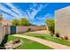 Expansive backyard featuring manicured artificial turf, brick walkways, and vibrant desert flora for outdoor enjoyment at 4317 E Glenrosa Ave, Phoenix, AZ 85018
