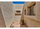 Private courtyard featuring textured walls, stone accents, and potted plants, creating a tranquil outdoor space at 4317 E Glenrosa Ave, Phoenix, AZ 85018