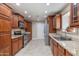 Well-equipped kitchen with ample wood cabinets, granite countertops, and stainless steel appliances at 4317 E Glenrosa Ave, Phoenix, AZ 85018