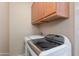 Convenient laundry room features modern appliances, cabinet storage, and ample workspace at 4317 E Glenrosa Ave, Phoenix, AZ 85018
