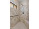 Updated shower with tasteful tile surround, bench, and handrail features window for natural light at 4317 E Glenrosa Ave, Phoenix, AZ 85018
