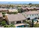 Overhead view of a neighborhood showcasing homes with private pools and well-maintained landscaping at 43998 W Palo Abeto Dr, Maricopa, AZ 85138