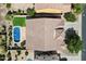 Aerial view of a house showing a private pool, artificial grass, and desert landscaping at 43998 W Palo Abeto Dr, Maricopa, AZ 85138