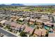 Expansive aerial view of a neighborhood with single-Gathering homes, desert landscaping, and community spaces at 43998 W Palo Abeto Dr, Maricopa, AZ 85138
