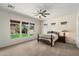 A bright bedroom with three windows and a dark wood bed frame at 43998 W Palo Abeto Dr, Maricopa, AZ 85138