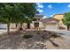 Well-kept home with desert landscaping, a two-car garage, and a neutral color scheme under a clear blue sky at 43998 W Palo Abeto Dr, Maricopa, AZ 85138