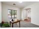 Bright home office featuring a large window, modern chair and a solid wooden desk, perfect for remote work at 43998 W Palo Abeto Dr, Maricopa, AZ 85138