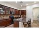 Well-appointed kitchen showcases rich wood cabinetry, granite countertops, and a convenient breakfast bar at 43998 W Palo Abeto Dr, Maricopa, AZ 85138