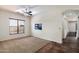 Neutral living room with tiled entryway, ample light from the large window, and an abstract painting at 43998 W Palo Abeto Dr, Maricopa, AZ 85138