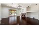 Inviting living area features a cozy fireplace, dark hardwood floors, and sliding glass doors opening to a pool at 43998 W Palo Abeto Dr, Maricopa, AZ 85138