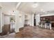 Open floorplan featuring tile and hardwood flooring, seamlessly connecting the living room and kitchen areas at 43998 W Palo Abeto Dr, Maricopa, AZ 85138