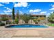 Backyard swimming pool with stone surround, waterfall feature, and lush landscaping at 43998 W Palo Abeto Dr, Maricopa, AZ 85138