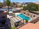 Aerial view of a backyard featuring a large pool, spa, and covered patio area at 44158 W Cypress Ln, Maricopa, AZ 85138