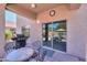 Inviting back patio with barbecue, and views of a pool, ideal for outdoor dining and relaxation at 44158 W Cypress Ln, Maricopa, AZ 85138