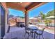 Charming back patio with outdoor seating, overlooking a pool and spa, perfect for entertaining at 44158 W Cypress Ln, Maricopa, AZ 85138