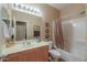 Bathroom featuring a shower-tub combo with curtain and a neutral-colored single sink vanity at 44158 W Cypress Ln, Maricopa, AZ 85138