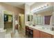 Bright bathroom featuring a shower, walk-in closet and vanity at 44158 W Cypress Ln, Maricopa, AZ 85138