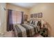 Bedroom featuring a decorative metal bed frame, carpeted floors, and ambient lighting at 44158 W Cypress Ln, Maricopa, AZ 85138