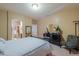 Bedroom featuring a dark wood bed frame, carpeted floors and Zebra print accent chair at 44158 W Cypress Ln, Maricopa, AZ 85138