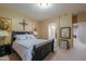 Bedroom featuring a dark wood bed frame, carpeted floors and access to the bathroom at 44158 W Cypress Ln, Maricopa, AZ 85138