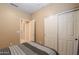 Bedroom featuring a double-door closet, carpeted floors, and neutral-colored walls at 44158 W Cypress Ln, Maricopa, AZ 85138
