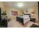 Bedroom featuring a dark wood bed frame and accent lighting at 44158 W Cypress Ln, Maricopa, AZ 85138