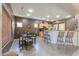 Spacious dining area with tile flooring, complemented by a breakfast bar and ample lighting, perfect for entertaining and Gathering gatherings at 44158 W Cypress Ln, Maricopa, AZ 85138