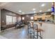 The dining area features a table with chairs, a breakfast bar with stools, and a window allowing natural light to illuminate the space at 44158 W Cypress Ln, Maricopa, AZ 85138