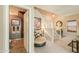 Inviting entryway showcasing the half bath, staircase, and a stylish chair, complemented by neutral tones and natural light at 44158 W Cypress Ln, Maricopa, AZ 85138