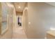 Neutral hallway with carpeted floor leading to various rooms in the home with a warm ambiance at 44158 W Cypress Ln, Maricopa, AZ 85138